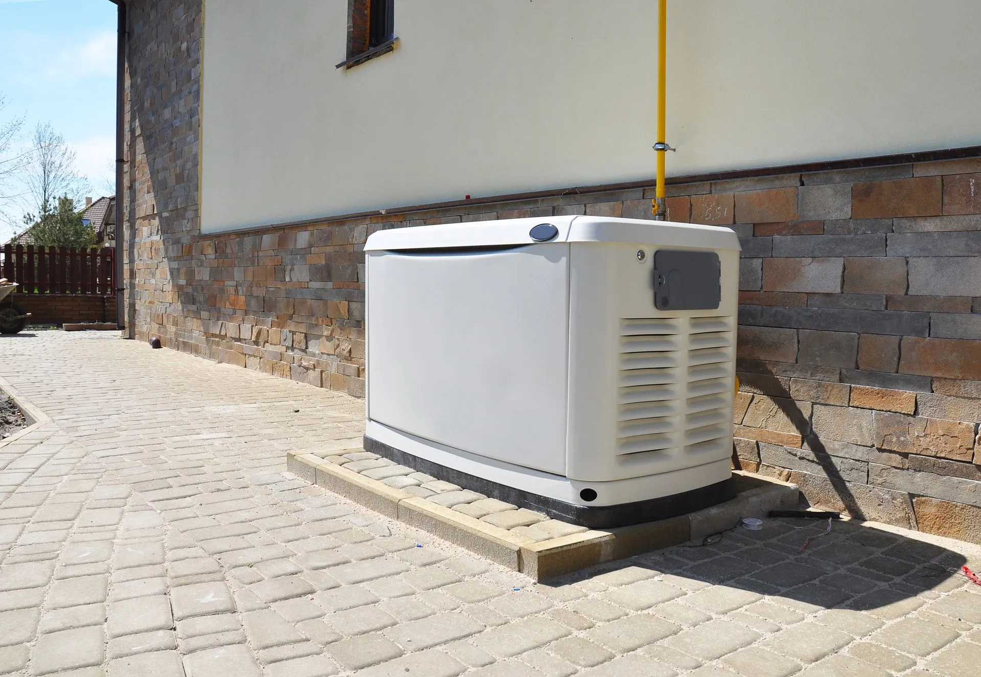 Whole-home standby generator installed beside a residence